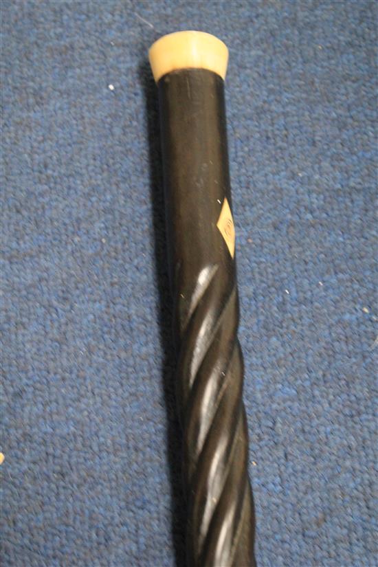 A late 19th / early 20th century ebony spiral twist turned walking cane, 37.25in.